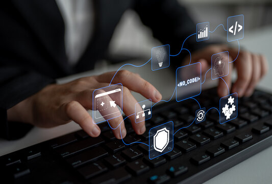 Hands Engaging with Digital Interface Representing No-Code Development on a Keyboard in a Modern Office Environment Quark.