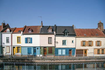 Fototapeta premium Historic Saint-Leu district along the River Somme in Amiens, France. The picturesque neighbourhood features colourful old townhouses, riverside canals, and traditional waterways 