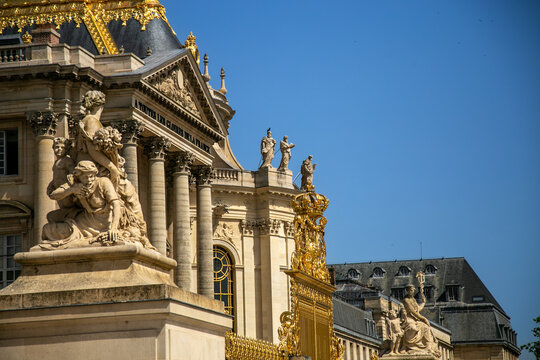 Opulent facade of the Palace of Versailles in France, showcasing intricate golden detailing, ornate decorations, and classical French architecture. The iconic royal ch&acirc;teau represents the grandeur