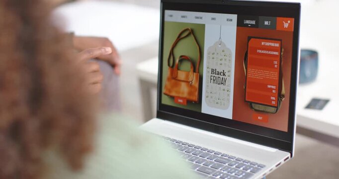 Couple spotting Black Friday tag on laptop while man pointing at trackpad selecting handbag at home