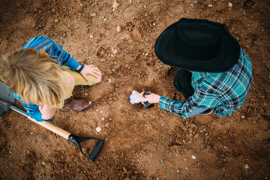 Two Little Boys Playing Together in the Dirt