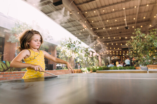girl playing ping pong outside