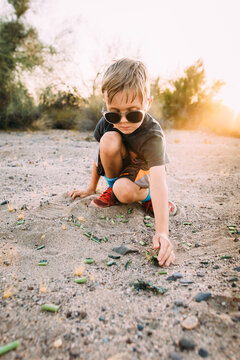 Boy in desert landscape with sunglasses