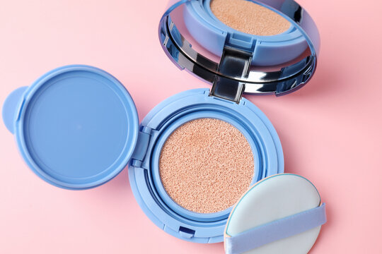 Cushion foundation on pink background, top view