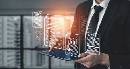 Obraz premium Businessman Using Tablet to Manage Documents and Graphs for Workflow Optimization in Modern Office Environment. Bitwise.