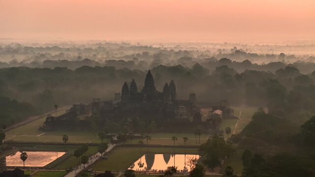 Aerial Drone view of the Majestic Angkor Wat temple complex in cambodia at Sunrise. UNESCO World Heritage Site.