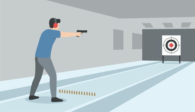 Shooter wearing red ear protection firing a handgun at a bullseye target in an indoor range with empty shell casings on the floor for marksmanship and firearm training sessions.