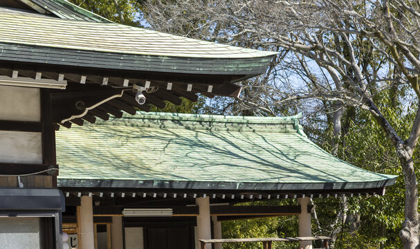 View of traditional Japanese temple roofs with green copper tiles and wooden eaves Osaka, Osaka, Japan.