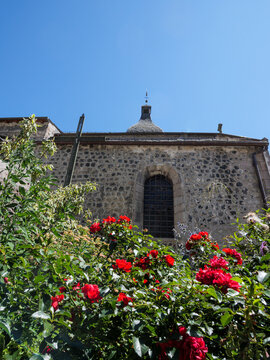 Historic Church Garden With Red Roses In Cantal France