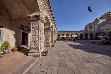 Fototapeta premium the Claustros de la Compañía unfold here in a vaulted colonial corridor where four centuries of religious history live quietly in every chiseled surface. Elaborate baroque relief work, intricate flora