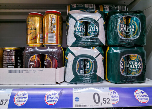 DENIA, SPAIN - Juny 18, 2026.Shrink wrapped multipacks of Carrefour Extra Malta beer cans on supermarket shelf in Spain showing affordable options for shoppers