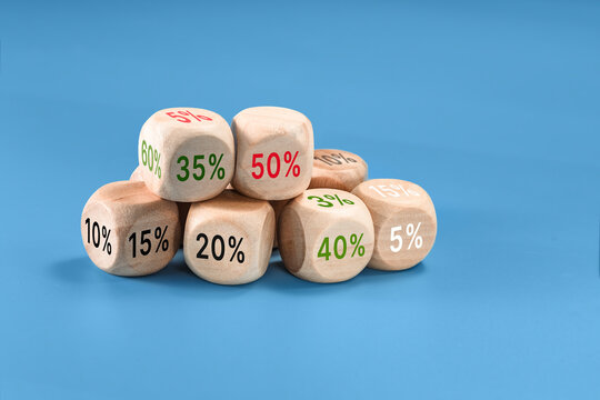 Stack of wooden blocks percentage markings on blue background