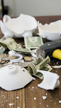 Broken piggy bank revealing money, savings, and debt crisis