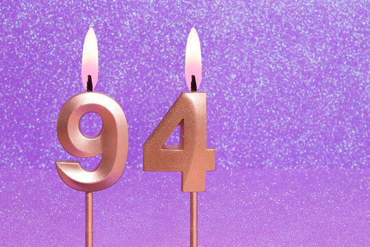 Number 94 on a pink background with blurred bright dots - Birthday or anniversary card with abstract blurred dots that glow
