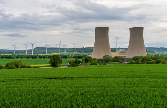 Grohnde Nuclear Power Plant in Germany, cooling towers and a reactor dome with the alternative power from wind turbines now feeding the grid