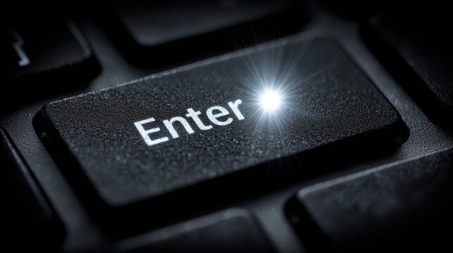 Close up view of a laptop enter key glowing brightly representing the modern remote work culture and the digital business landscape