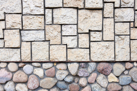 Stone tile facade with river stone foundation