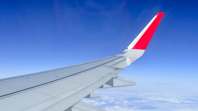 Airplane wing above clouds in bright daylight with clear blue sky ideal for travel blogs aviation editorial tourism marketing and social media visuals, 5 May 2026 Subitica, Serbia