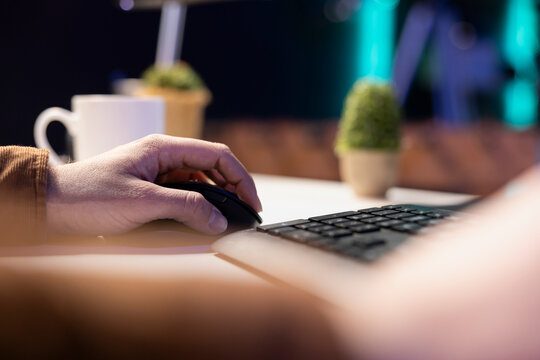 Teleworking computer technician typing on keyboard, implementing security measures to protect company systems and data. Remote IT employee at home debugging code for software, close-up.