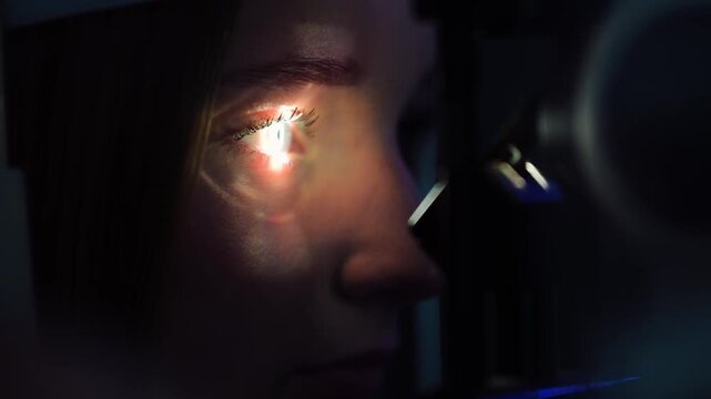 Eye examination with a machine at an optometrist's office in a city during daylight