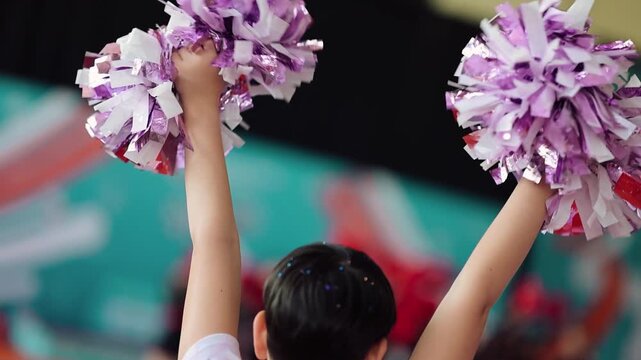 Cheerleading practice at the gym with pom poms in a lively setting