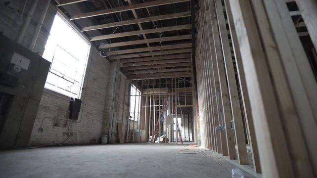 Dolly shot construction wood framing brick walls electrical panel