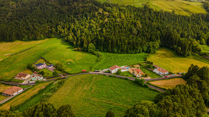 Aerial high angle view of rural houses and green fields in Furnas valley © Андрей Нелупов