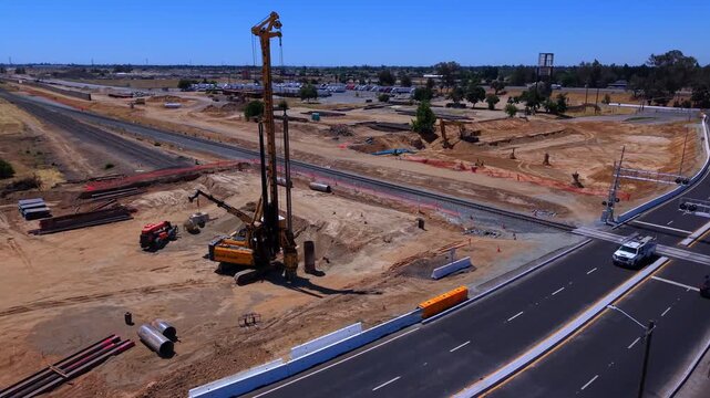 Aerial Drone View of Traffic Near California High Speed Rail Construction and Railroad Crossing