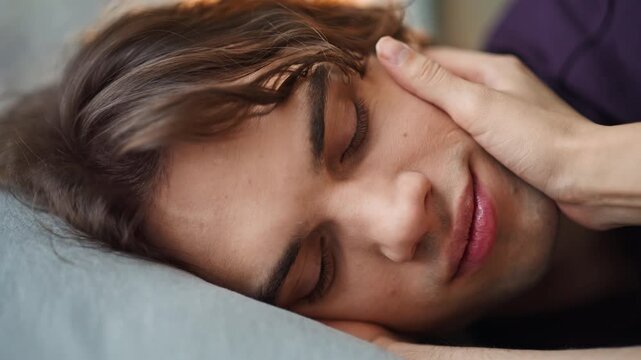 Lady fingers touching boyfriend face romantic morning closeup. Man opening eyes