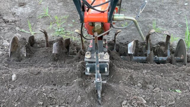 Agricultural power tiller cultivating soil for planting