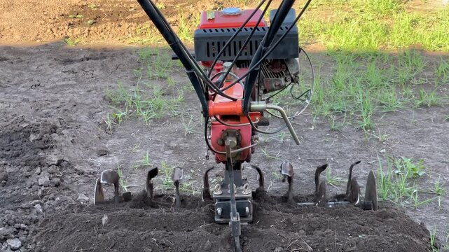 Motorized cultivator tilling the soil for planting