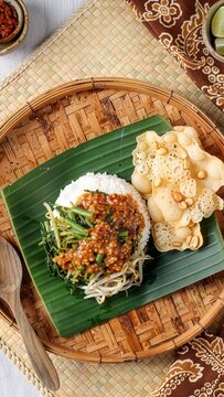 Traditional Javanese nasi pecel with peanut sauce and rempeyek