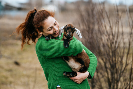 Woman Bonding with Nubian Goat on Rural Farm