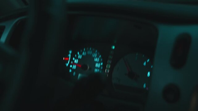 Glowing car dashboard speedometer during night driving