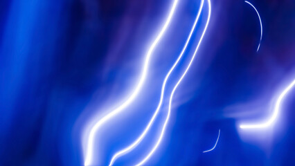 Abstract glowing purple and blue light wave creating a dynamic curved streak, fluid neon energy trail on a dark background for futuristic digital graphic design
