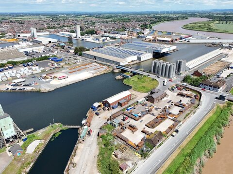 Aerial view of the industrial port facilities, warehouses, and storage yards along the river in Goole, England, United Kingdom.