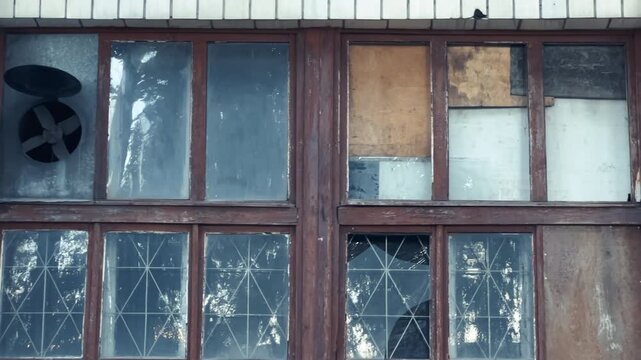 Abandoned Soviet Era Building Windows with Broken Glass and Boarded Panels | Long Shot Panning Left to Right | Urban Exploration Facade Detail