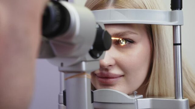 Caucasian woman undergoing eye examination with slit lamp, focused on her eye as the device illuminates it, medical office setting with soft lighting and neutral background