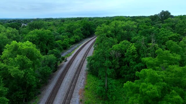 rossing the train tracks amidst green trees