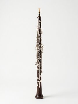 A professional dark wood oboe with silver keys and a reed on a clean white background