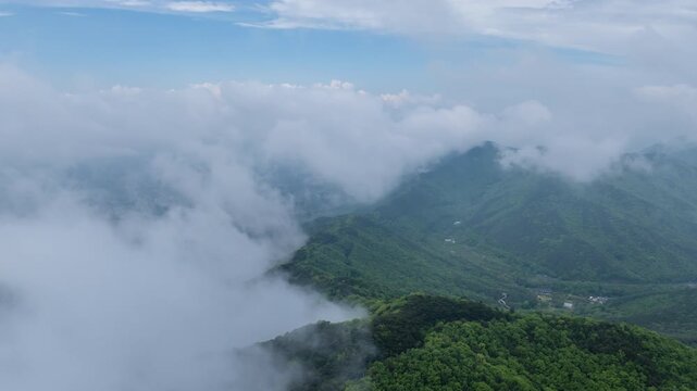 Aerial hyperlapse of thick fog and mist moving over Seongjusan Mountain in Boryeong, South Korea