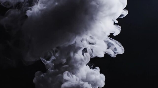 A dense plume of white smoke rises against a dark background