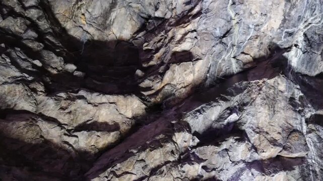 Rough Limestone Tunnel Wall Texture with Natural Erosion Patterns. Detailed rough limestone tunnel wall texture featuring natural erosion patterns, uneven rocky surface, and earthy tones. 