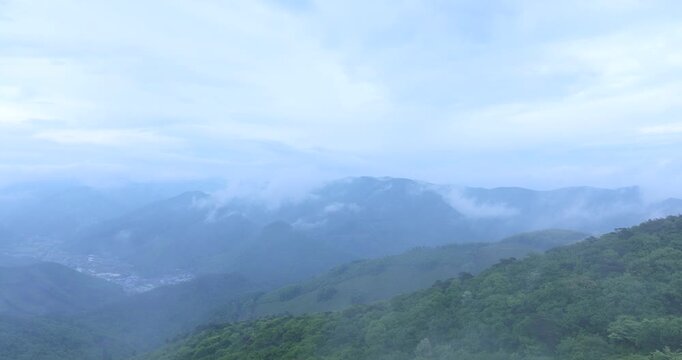 seongjusan, boryeong, south korea, aerial view, drone shot, hyperlapse, timelapse, mountain fog, mist, misty morning, cloudy sky, fast motion, atmospheric, majestic nature, serene landscape, pine tree