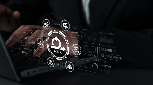 Business professional using laptop to implement agile methodology with digital interface displaying data analytics and project management concepts. Entropy.