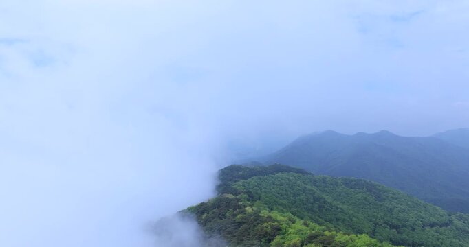 seongjusan, boryeong, south korea, aerial view, drone shot, hyperlapse, timelapse, mountain fog, mist, misty morning, cloudy sky, fast motion, atmospheric, majestic nature, serene landscape, pine tree