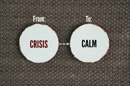 Two circles of paper with the words from crisis to calm. the psychological and practical journey of transitioning from a state of intense panic, chaos