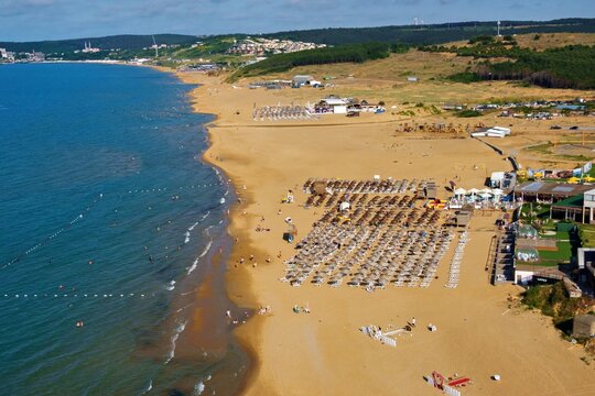 Aerial view of Kilyos shore featuring rows of sun loungers and umbrellas on the sandy beach along the Black Sea coast in Sariyer, Istanbul, Turkey.
