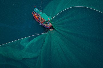 Aerial view of fishing boats using purse seine nets to catch anchovies in the coastal waters of Tuy An, Phu Yen, Vietnam. © ThanhSon
