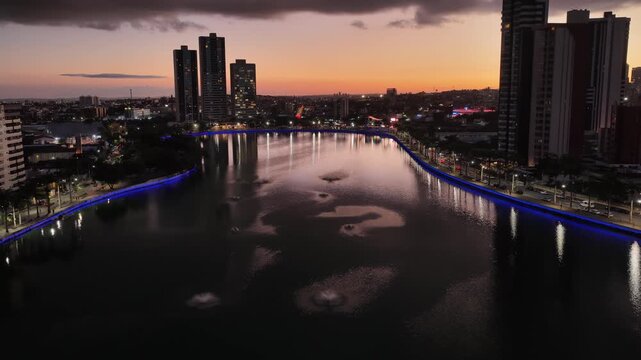 Sunset Lakefront Park In Campina Grande In Paraiba Brazil. Illuminated Lake. Downtown District. Lakefront Park In Campina Grande In Paraiba Brazil. Highrise Buildings Scenery. Sunset Sky Landscape.